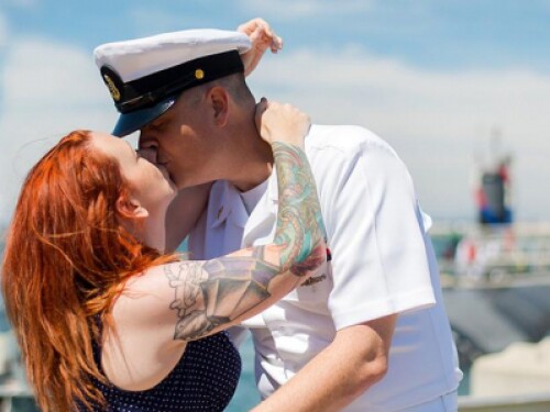 military serviceman and partner kiss