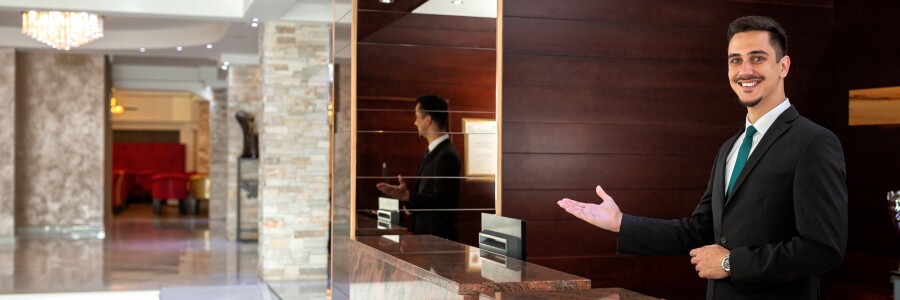 welcoming hotel concierge behind desk