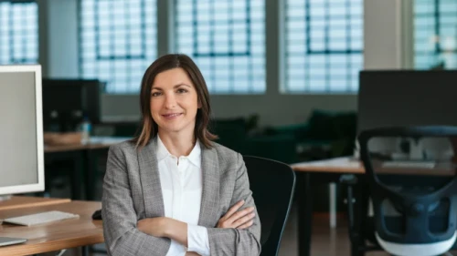 woman with folded arms in a professional office setting