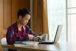 student on laptop at home