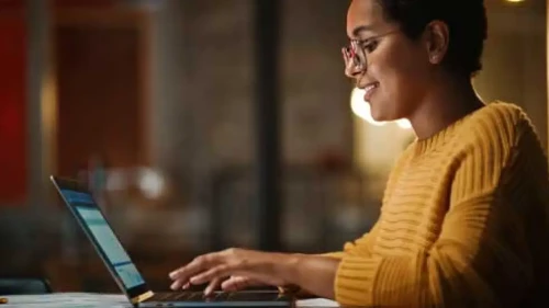 Woman typing on laptop