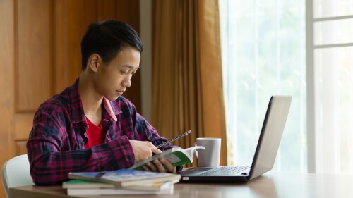 student on laptop at home