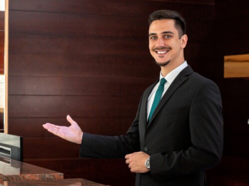welcoming hotel concierge behind desk