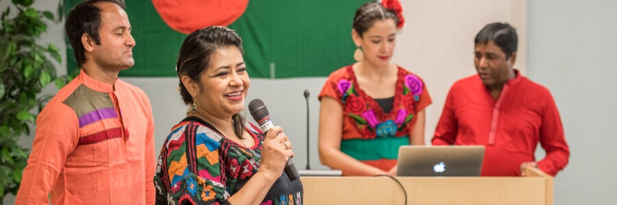 professionals dressed in bright cultural attire giving a presentation