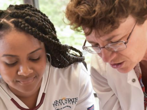 nursing professor and nursing student working with a stethoscope
