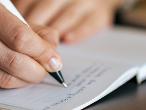 Creative Writing Hand with Pen on Journal