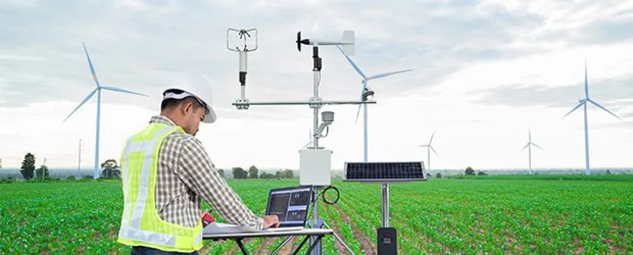 Scientist collects data in a windmill field