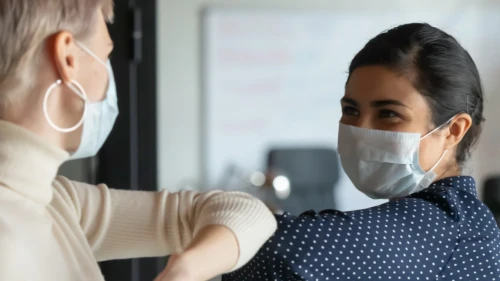 Women meeting wearing masks