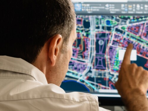 technologist pointing to at a digital map on computer monitor