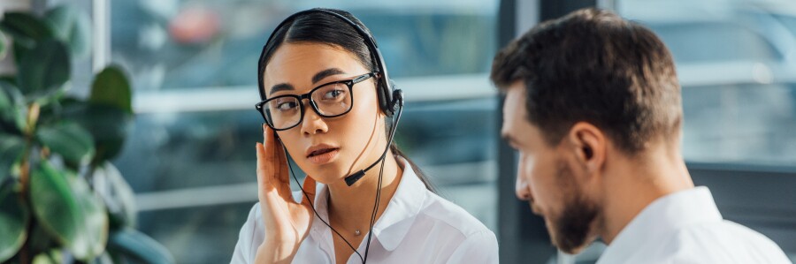 interpreter listens to caller on a headset