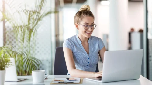 smiling female using a laptop computer