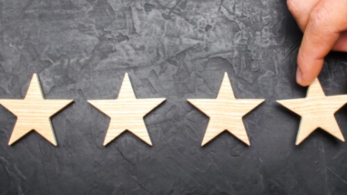 5 wooden stars placed on a dark background
