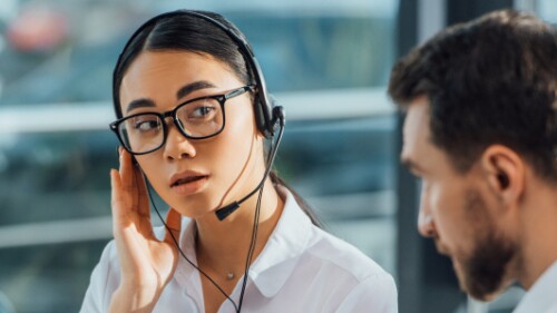 interpreter listens to caller on a headset