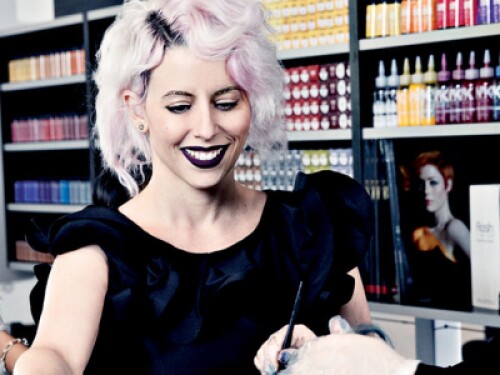 professional hairstylist training a stylist student on hair coloring treatment