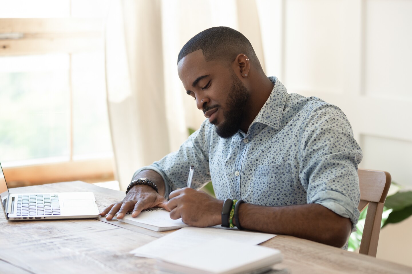 Focused,African,American,Man,Student,Freelancer,Making,Notes,Studying,Working