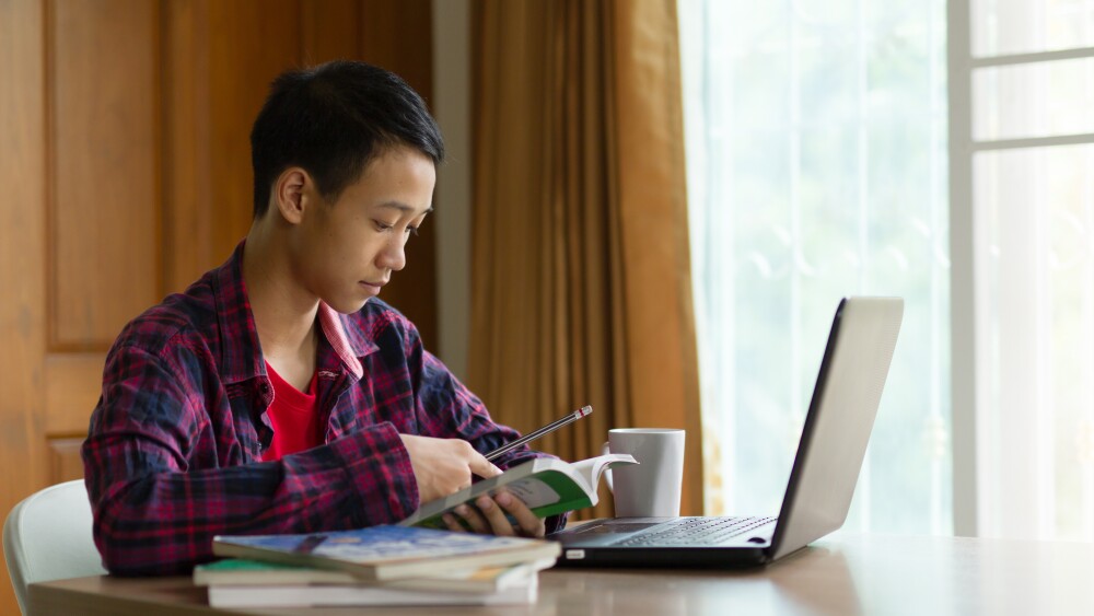 student on laptop at home