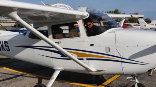 pilot gets into small airplane