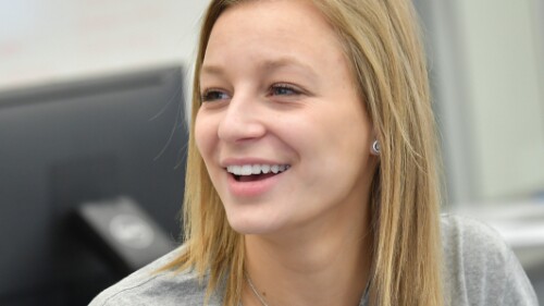 student smiling in a classroom