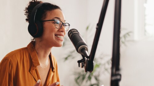 woman recording podcast in studio