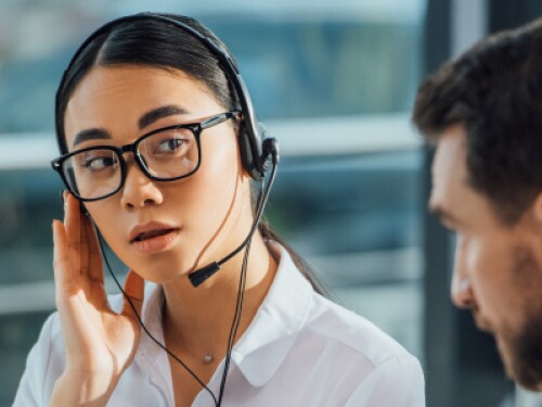 interpreter listens to caller on a headset