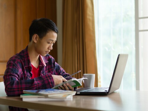 student on laptop at home