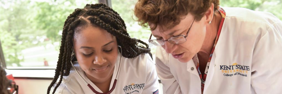 nursing professor and nursing student working with a stethoscope