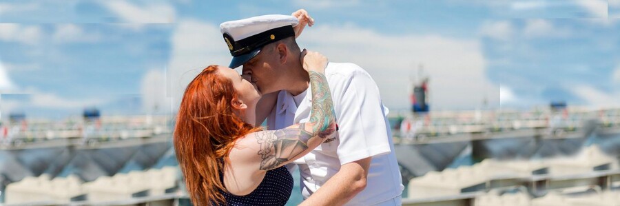 military serviceman and partner kiss