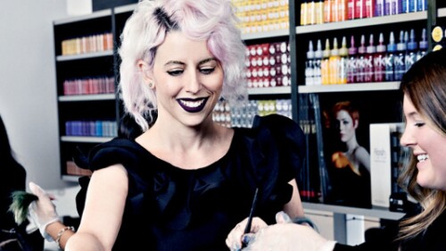 professional hairstylist training a stylist student on hair coloring treatment