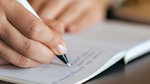 Creative Writing Hand with Pen on Journal