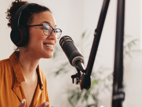 woman recording podcast in studio