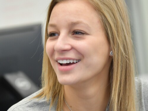 student smiling in a classroom