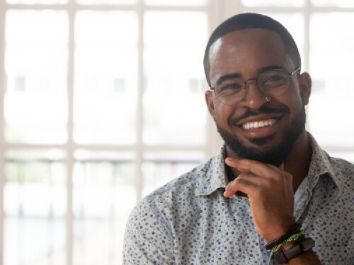 professional with glasses smiling