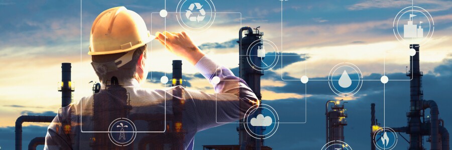 environmental engineer technician with a hard hat looking out over a power plant