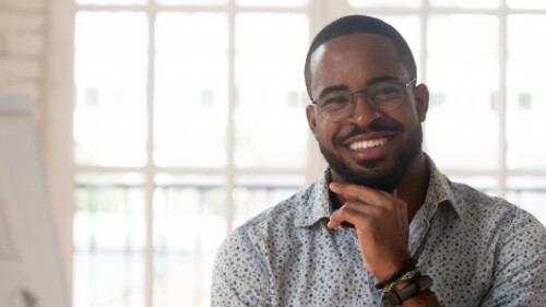 professional with glasses smiling