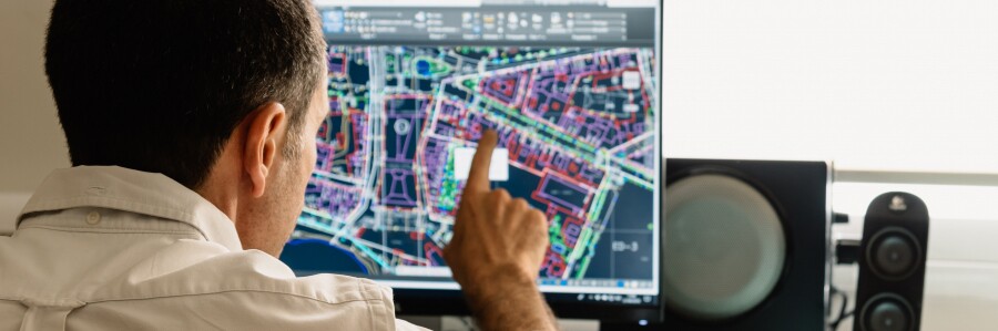 technologist pointing to at a digital map on computer monitor