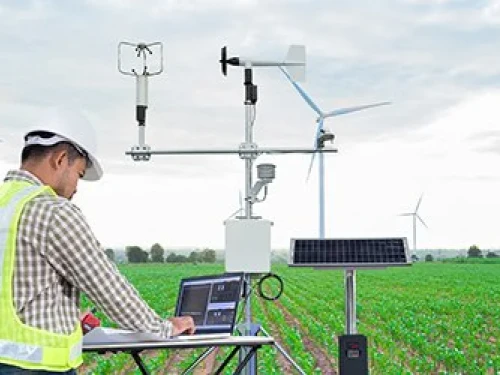 Scientist collects data in a windmill field