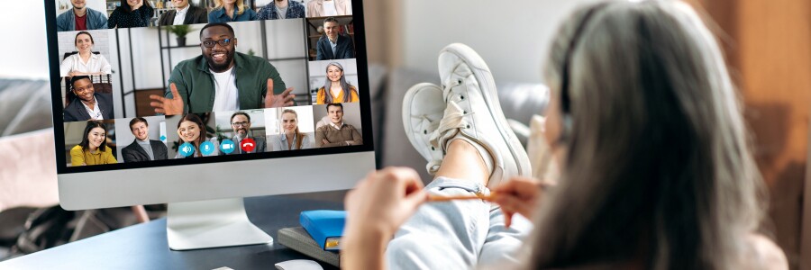student with feet on desk participating in virtual group conference from comfort of home