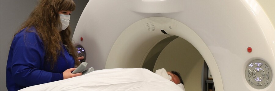 radiologic technician performing diagnostic for computed tomography imaging