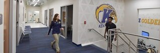 athletic trainers walking through Kent athletic facility