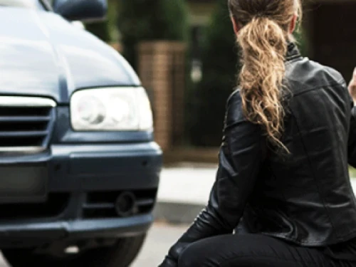 Lady in front of car