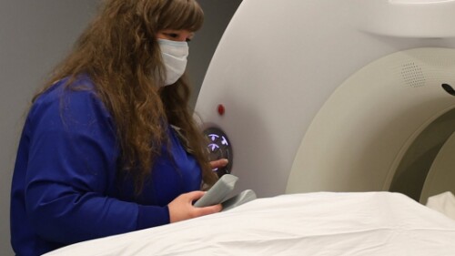 radiologic technician performing diagnostic for computed tomography imaging