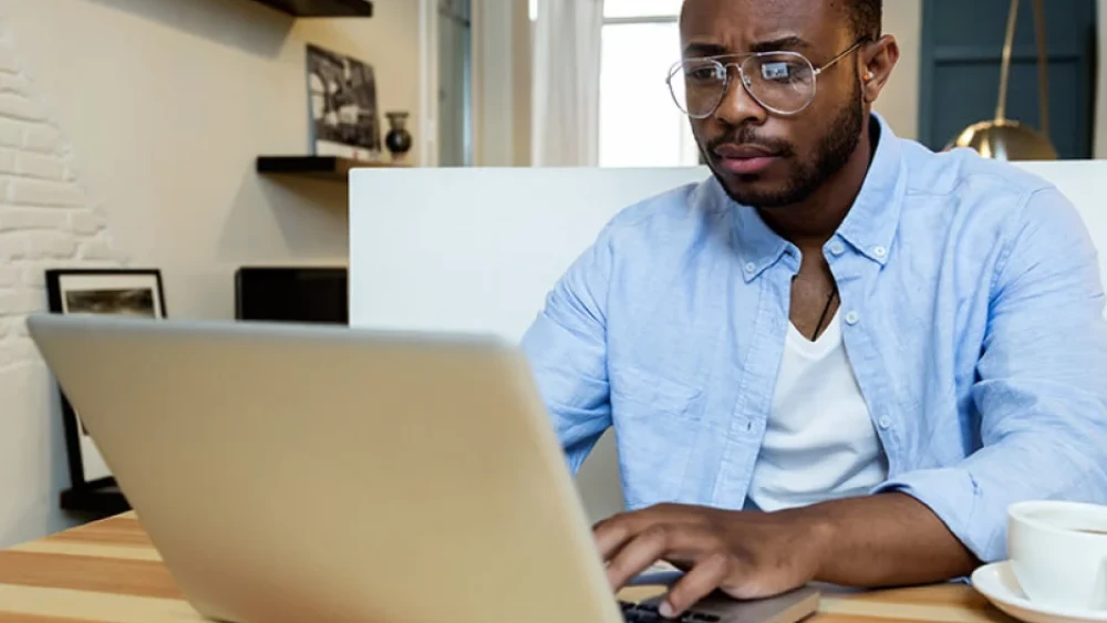 man studying at home for online degree