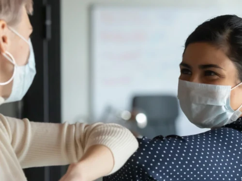 Women meeting wearing masks